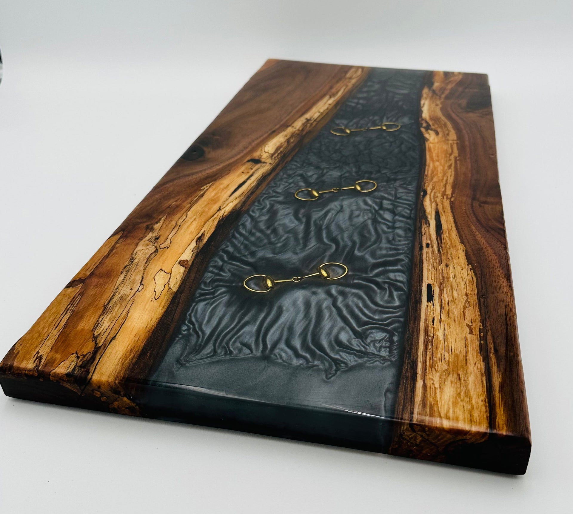 Introducing our latest Charcuterie Board - Handcrafted Black Walnut Charcuterie Board with Black Resin Inlaid with Gold Bridle Bit